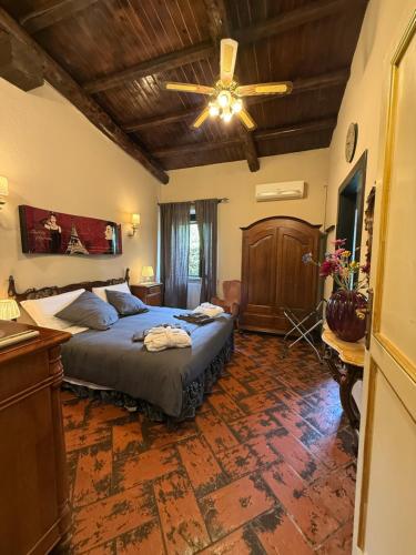 a bedroom with a bed and a ceiling fan at Almanuda - Naturist Village - Adults Only in Sutri