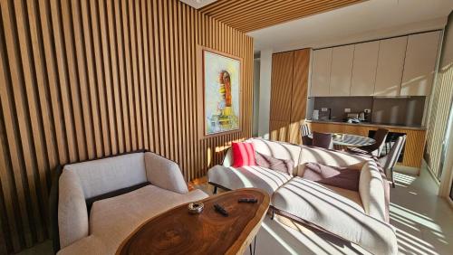 a living room with a couch and a table at Whisky Green Coast Hotel & Apartments in Palasë