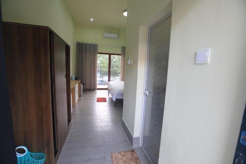 a hallway with a door to a bedroom with a bed at M Y hotel in Dili