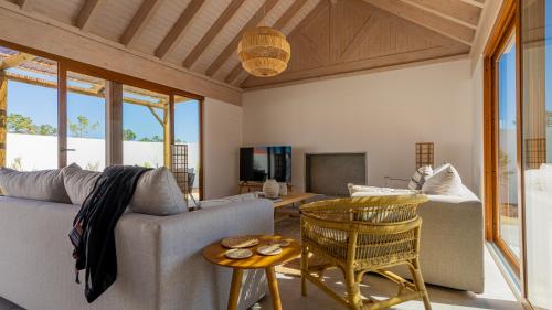 a living room with a couch and a table at Pestana Comporta Village Residences in Comporta