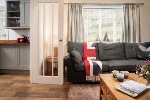 a living room with a couch and a table at Beach Approach House - 30 steps from beach - Luxury house - kids slide and chill-out room - amazing location - garden in Filey