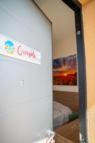 a mirror in a room with a sign on a wall at roveleto camere in Roveleto