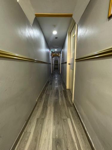 a long hallway with a wooden floor in a building at SS Grey Hotel kl in Kuala Lumpur