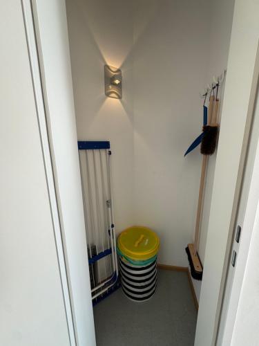 a room with a yellow stool next to a radiator at K9 Wohnungen in Münster