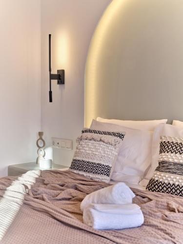 a bedroom with a bed with two towels on it at Marjay Boutique in Parikia