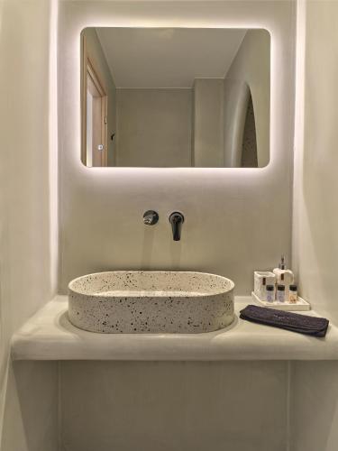 a bathroom sink with a large mirror above it at Marjay Boutique in Parikia