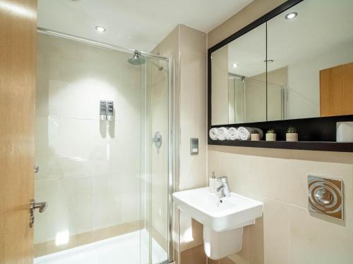 a bathroom with a sink and a shower at Leeds Dock 2BDR 2BA Balcony & River View in Leeds