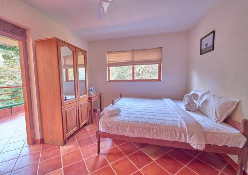 Postel nebo postele na pokoji v ubytování Jade Munnar Pool Resort