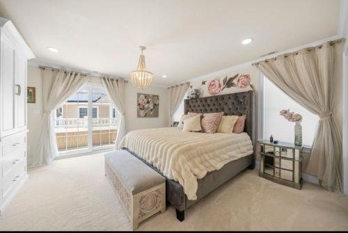 a bedroom with a large bed and a window at Paradise on Paradise Way in North Wildwood