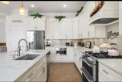a kitchen with white cabinets and a stainless steel appliance at Paradise on Paradise Way in North Wildwood