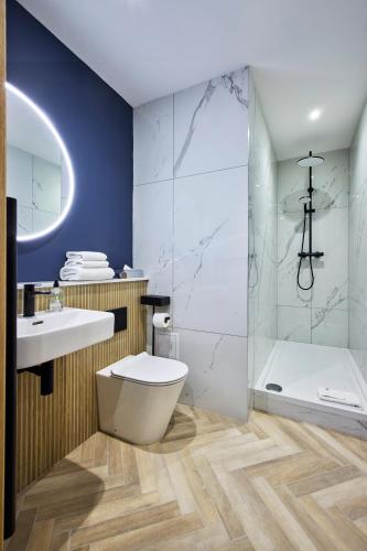 a bathroom with a toilet and a sink and a shower at Handel's Hotel in Dublin