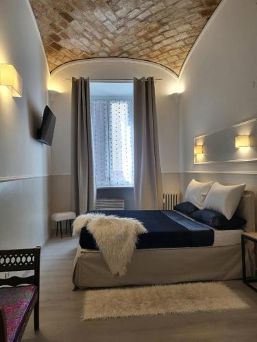 a bedroom with a large bed with a large window at Monteoppio one in Rome