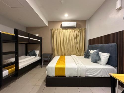 a bedroom with two beds and a bunk bed at SS Grey Hotel kl in Kuala Lumpur