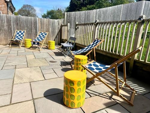 a group of chairs sitting on a patio at Five bedroom family house in St. Leonards