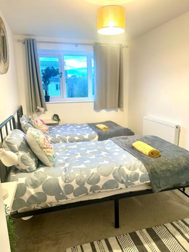 two twin beds in a room with a window at Five bedroom family house in St. Leonards