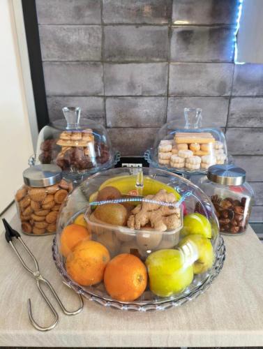 a table with a plate of fruit and other foods at Luz de Salento B&B in Lecce