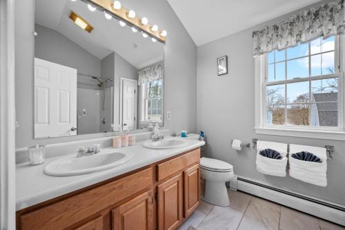 a bathroom with a sink and a toilet and a mirror at Velocity Residence in Worcester