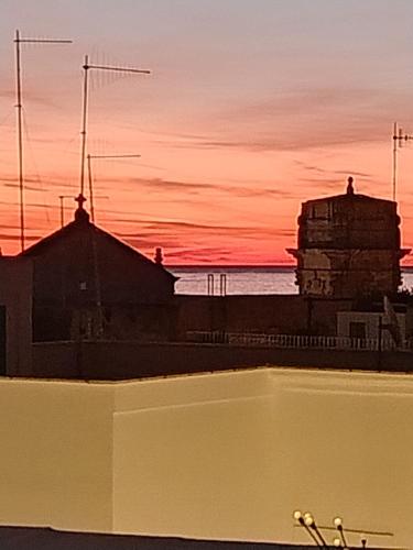 a bath tub with a sunset in the background at Donna Vita in Monopoli