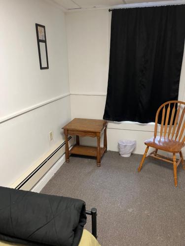 a room with a table and a chair and a window at Art Gallery Hostel in Whitefield