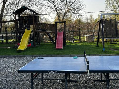 a ping pong table in front of a playground at Cabana Diana in Avrig