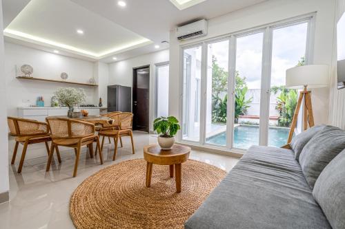 a living room with a couch and a table at From Sunrise to Starlight - Balis Best View is Waiting in Nusa Dua