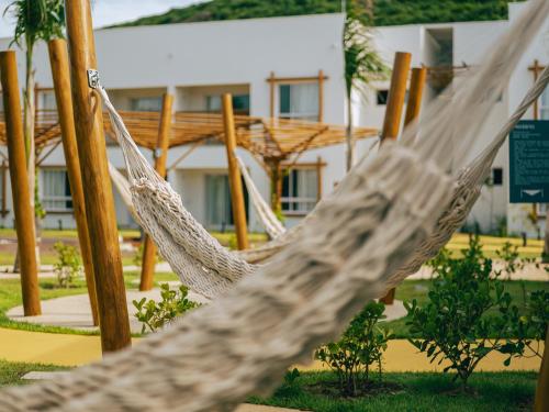 a hammock in front of a building at Pipa Privilege Ocean Oficial in Pipa