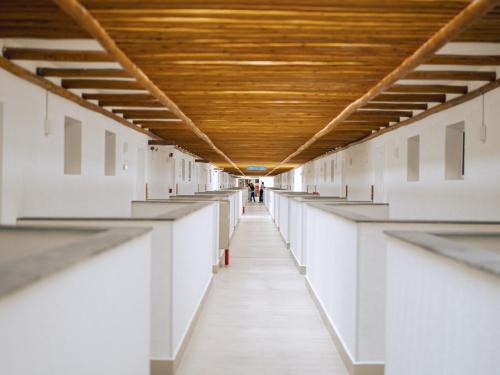 an empty hallway of a building with a wooden ceiling at Pipa Privilege Ocean Oficial in Pipa