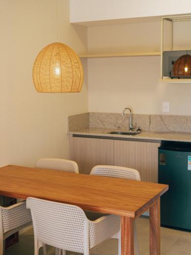 a kitchen with a wooden table and chairs at Pipa Privilege Ocean Oficial in Pipa