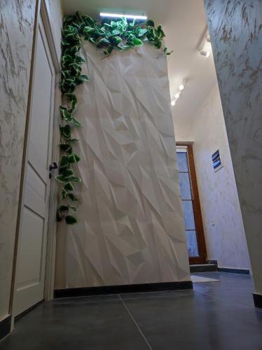a hallway with a wall with a plant on it at Our Village in Ashtarak