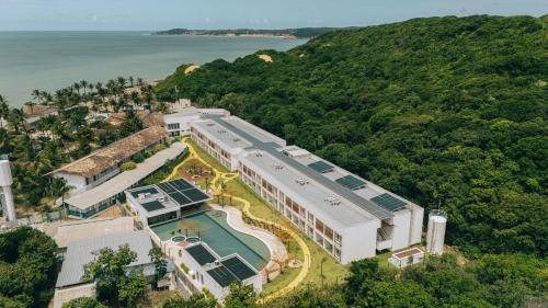 an aerial view of a building with a swimming pool at Pipa Privilege Ocean Oficial in Pipa