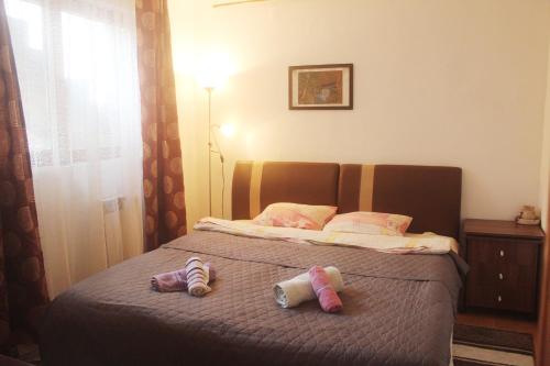 a bedroom with a bed with two stuffed animals on it at Apartment Baščaršija-parking i klima in Sarajevo