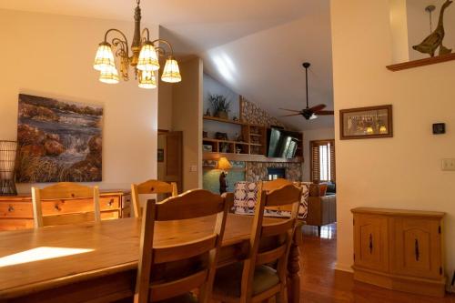 a dining room and living room with a table and chairs at Hideaway Riverfront Cabin in Kernville with Universal EV Charger in Kernville