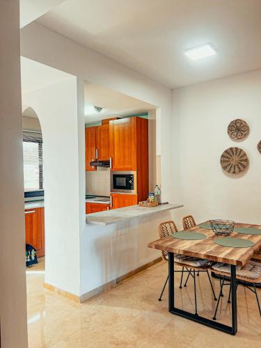 a kitchen with a table and chairs in a room at CN-340 Suites in Estepona