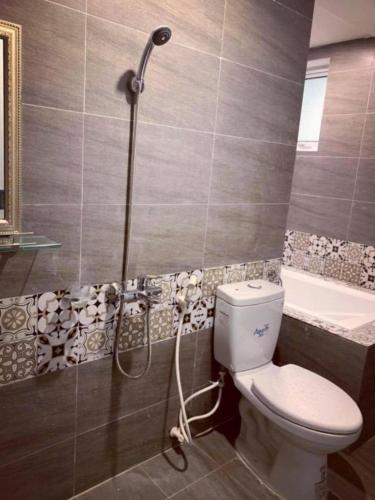 a bathroom with a shower with a toilet and a tub at Villa La Senlis, biệt thự kiểu Pháp in Hòa Bình