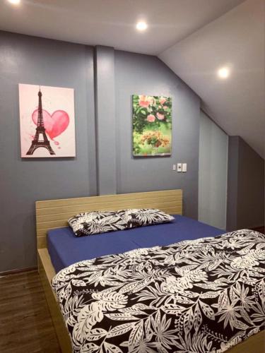 a bedroom with a bed and a tower at Villa La Senlis, biệt thự kiểu Pháp in Hòa Bình