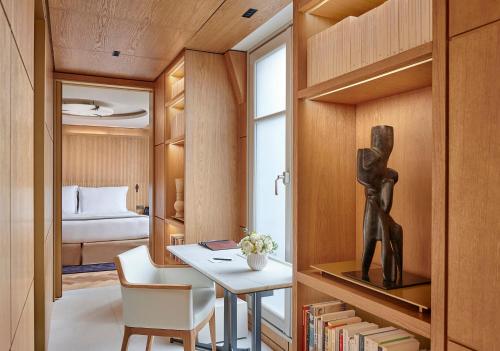 a room with a desk and a bedroom with a bed at Mandarin Oriental Lutetia, Paris in Paris