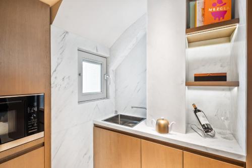 a kitchen with a sink and a microwave at Mandarin Oriental Lutetia, Paris in Paris