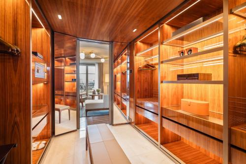 a room with wood paneling and a hallway with shelves at Mandarin Oriental Lutetia, Paris in Paris