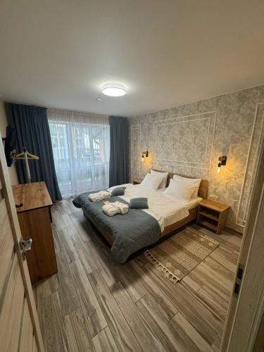 a bedroom with a large bed in a room at Guest House Zatyshnyi Dvir in Bukovel