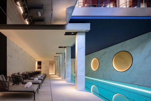a restaurant with a blue wall and a row of chairs at Mandarin Oriental Lutetia, Paris in Paris