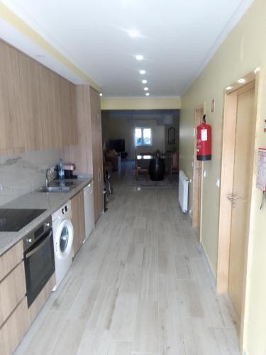 a kitchen with a washer and dryer in a room at Casa do Alves Azibo in Bragança