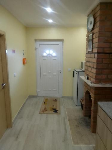 a room with a white door and a brick wall at Casa do Alves Azibo in Bragança