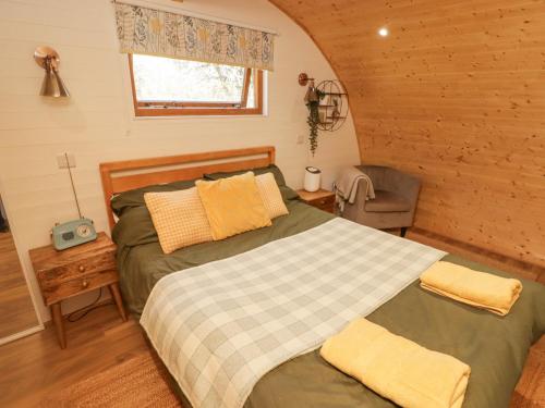 a bedroom with two beds in a log cabin at Cabanau Bach in Caerphilly