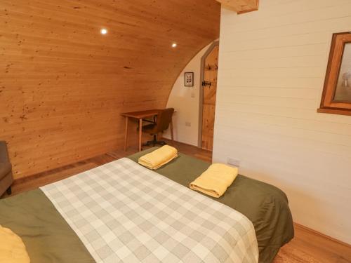 a bedroom with a bed in a wooden room at Cabanau Bach in Caerphilly