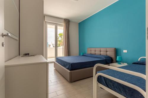 Ένα ή περισσότερα κρεβάτια σε δωμάτιο στο Case vacanze Blue Bay Resort