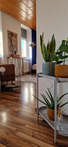 a living room with potted plants on shelves at MALA Modern Vienna Flair Apartment Donaustadt in Vienna