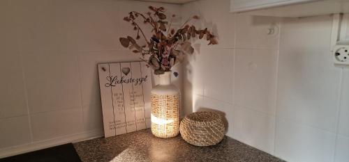 a vase with flowers in it sitting on a counter at MALA Modern Vienna Flair Apartment Donaustadt in Vienna