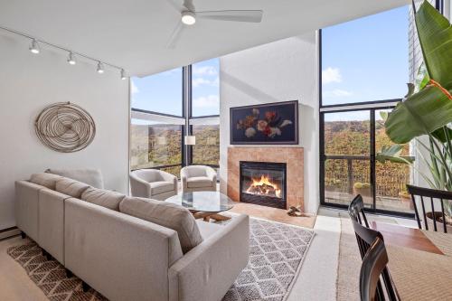 a living room with a couch and a fireplace at 7 Pelican! Sweeping Ocean Views & Front Row Beach Access in Watsonville