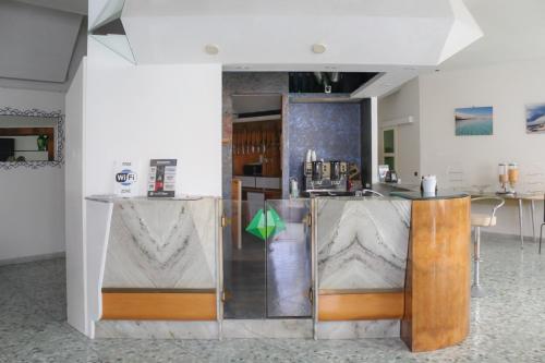 a room with a kitchen with a counter top at Hotel Pietra Verde in Otranto