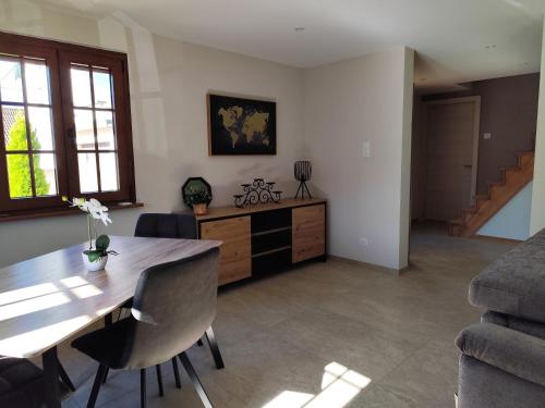 - un salon avec une table à manger et un canapé dans l'établissement Maison Thérèse 2-4 personnes, à Roeschwoog